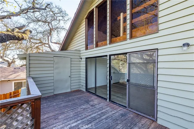 a view of a house with a wooden deck