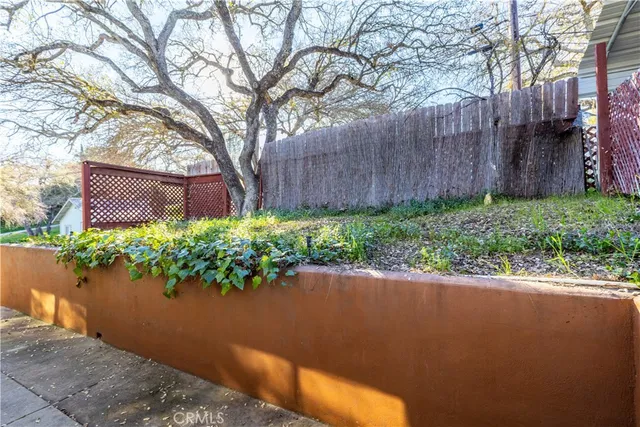 a backyard of a house with a yard and outdoor seating