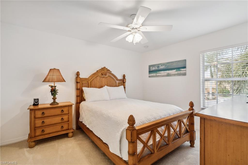 20048 Heatherstone Way, Unit 1 Estero, FL 33928 - Photo 15 of 20 a white bed sitting in a bedroom next to a window