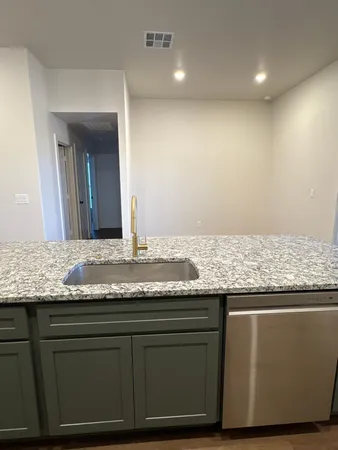 a bathroom with a granite countertop sink and a large mirror