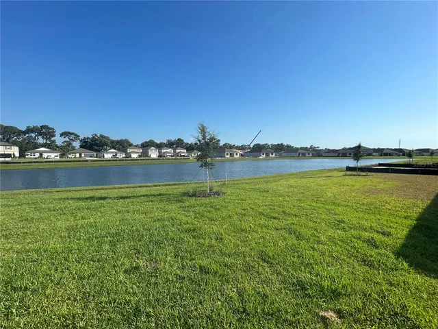 a view of a house and a yard with lake view