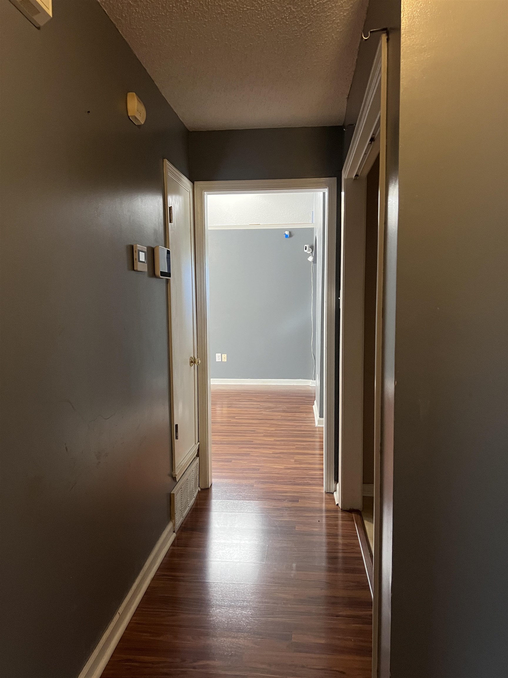 4005 Long Creek Road Memphis, TN 38125 - Photo 21 of 36 Wood-finish flooring throughout the hallway and adjoining room, with a neutral wall color