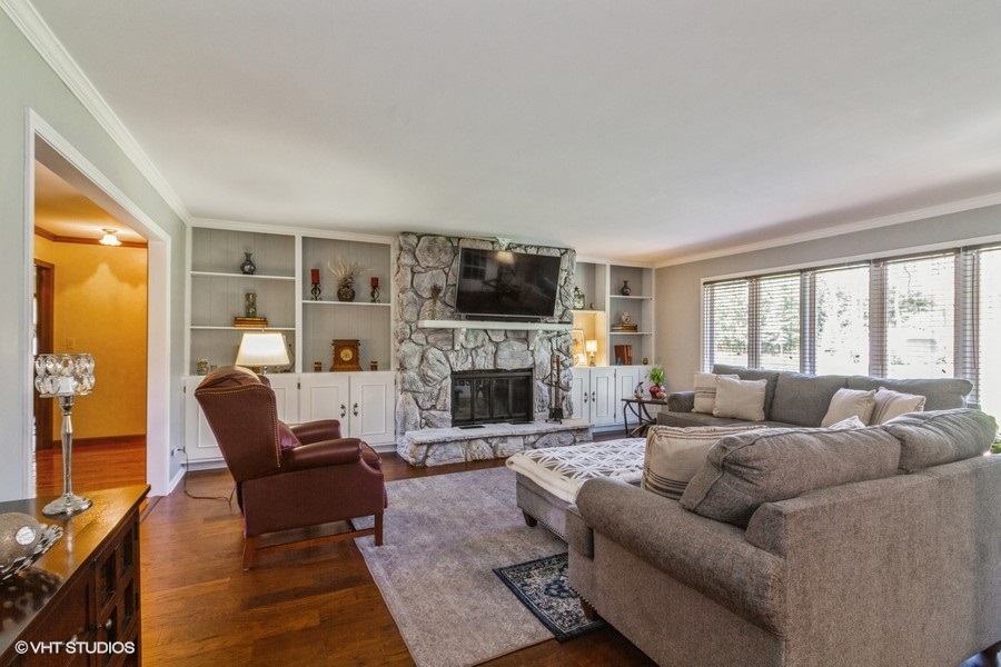 907 Powers Road Woodstock, IL 60098 - Photo 11 of 21 a living room with fireplace furniture and a flat screen tv