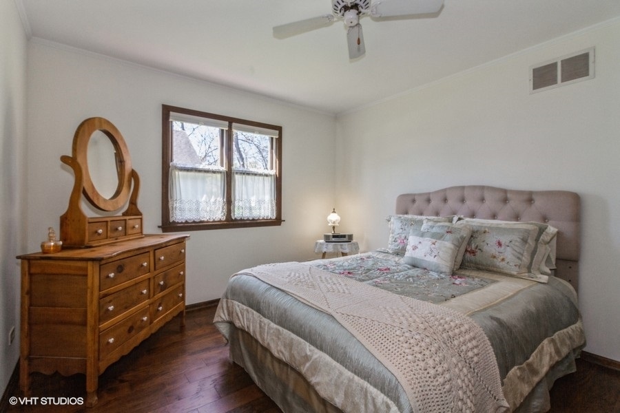 907 Powers Road Woodstock, IL 60098 - Photo 16 of 21 a bedroom with a bed and a dresser