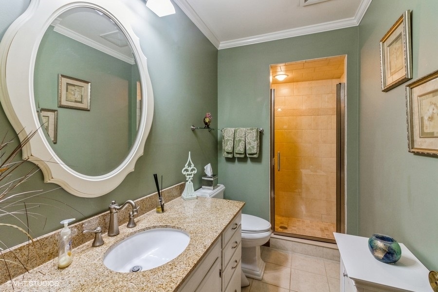 907 Powers Road Woodstock, IL 60098 - Photo 17 of 21 a bathroom with a granite countertop sink mirror vanity and toilet