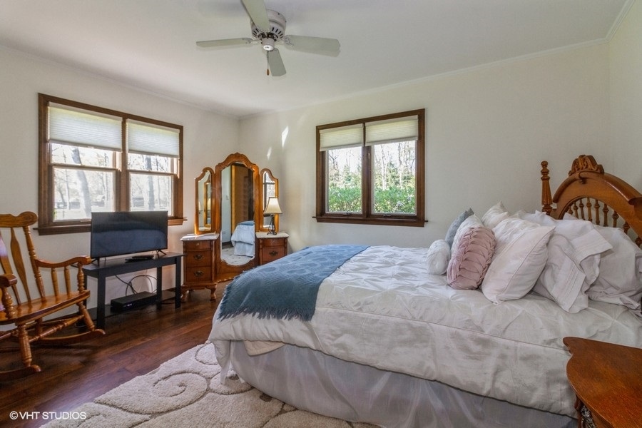 907 Powers Road Woodstock, IL 60098 - Photo 18 of 21 a bedroom with a bed large windows and a flat screen tv