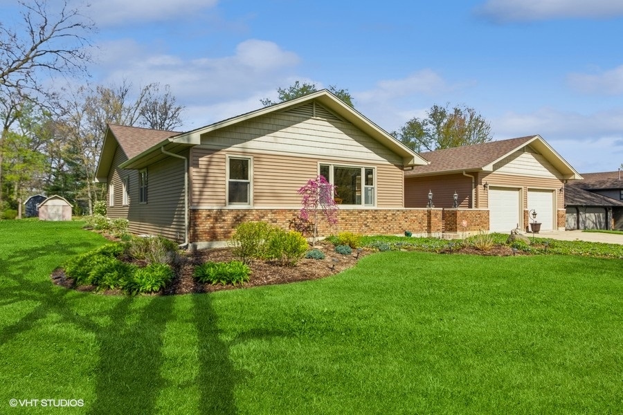 907 Powers Road Woodstock, IL 60098 - Photo 3 of 21 a view of a house with a yard and potted plants