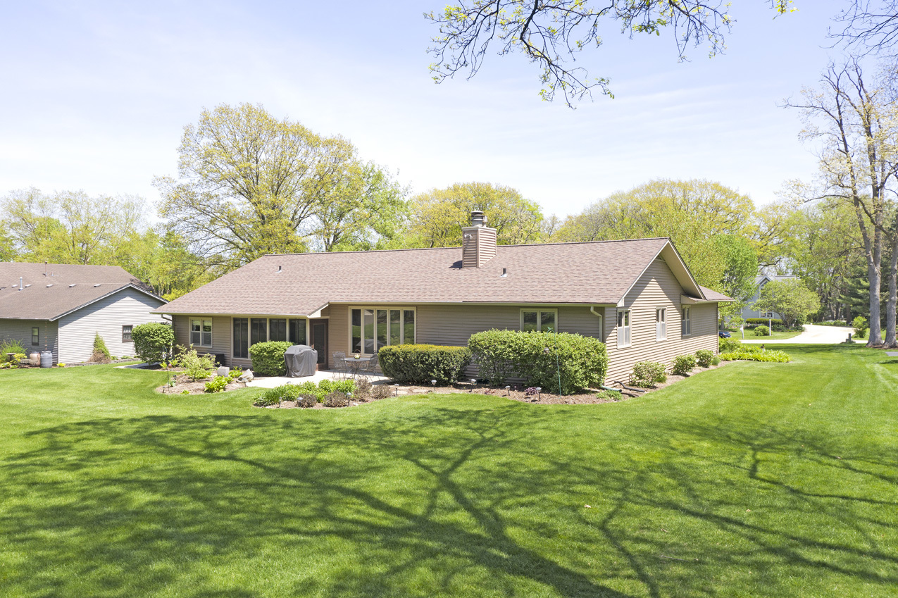 907 Powers Road Woodstock, IL 60098 - Photo 5 of 21 a front view of a house with a yard