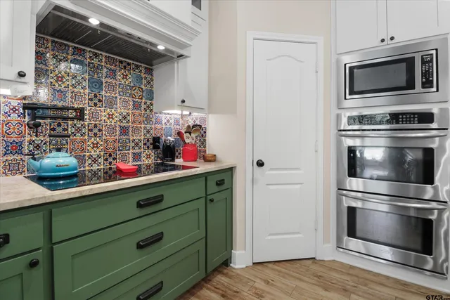 a kitchen with stainless steel appliances and wooden cabinets