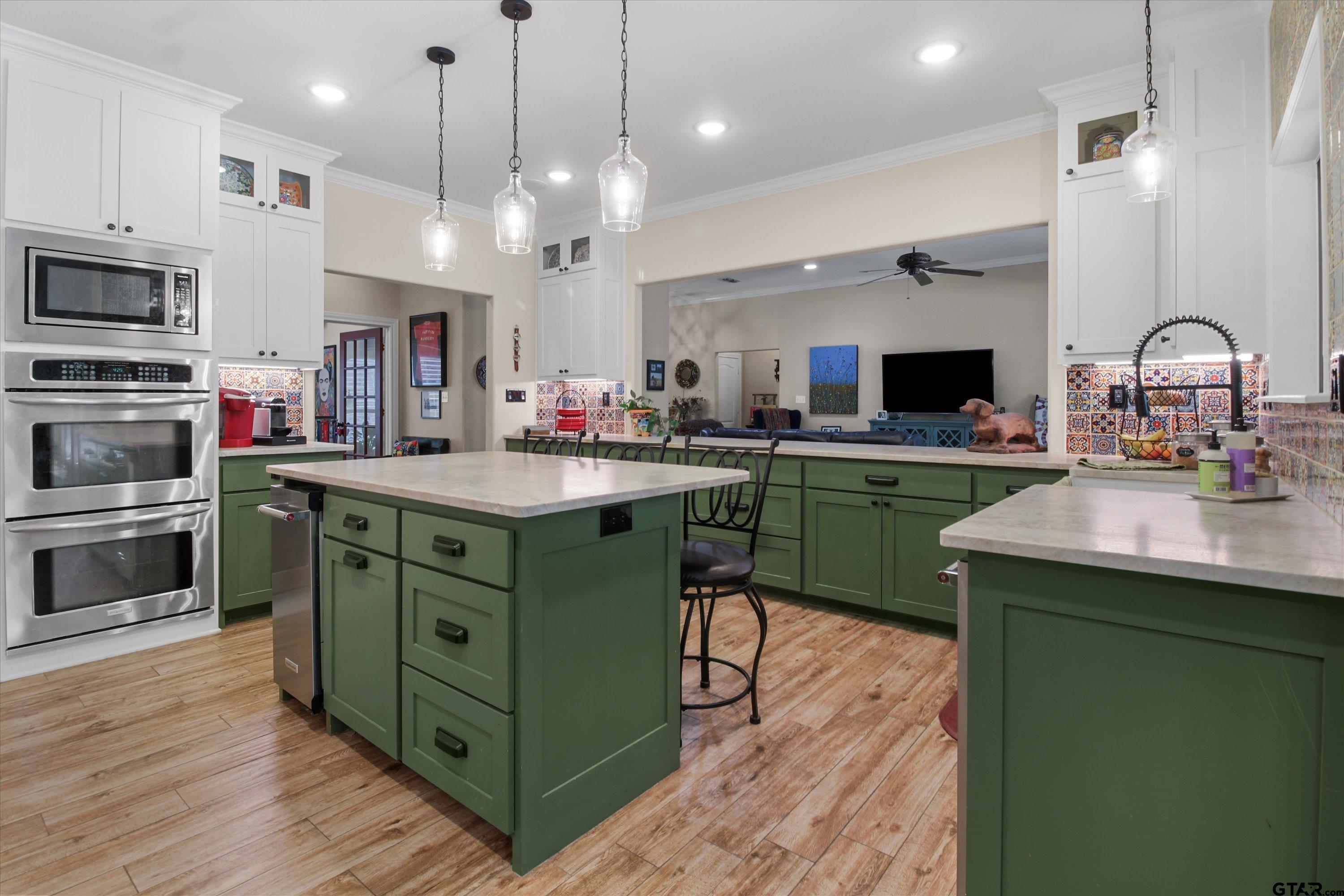 18551 Lazy Lane Flint, TX 75762 - Photo 15 of 45 a kitchen with kitchen island a sink stainless steel appliances and cabinets