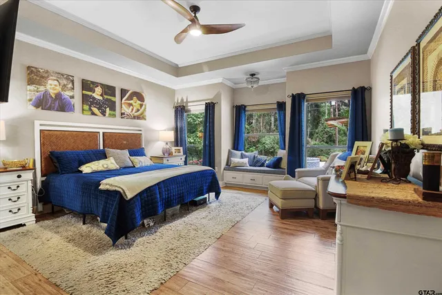 a bedroom with a large bed couch and a large window