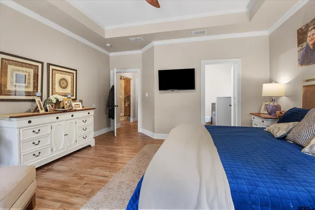 a bedroom with furniture and a flat screen tv