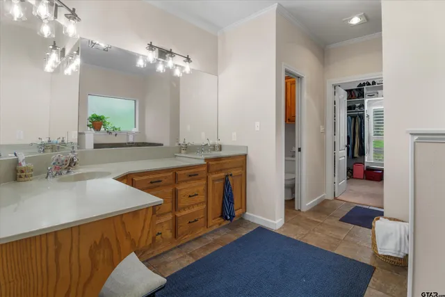 a spacious bathroom with a granite countertop sink a mirror and a shower