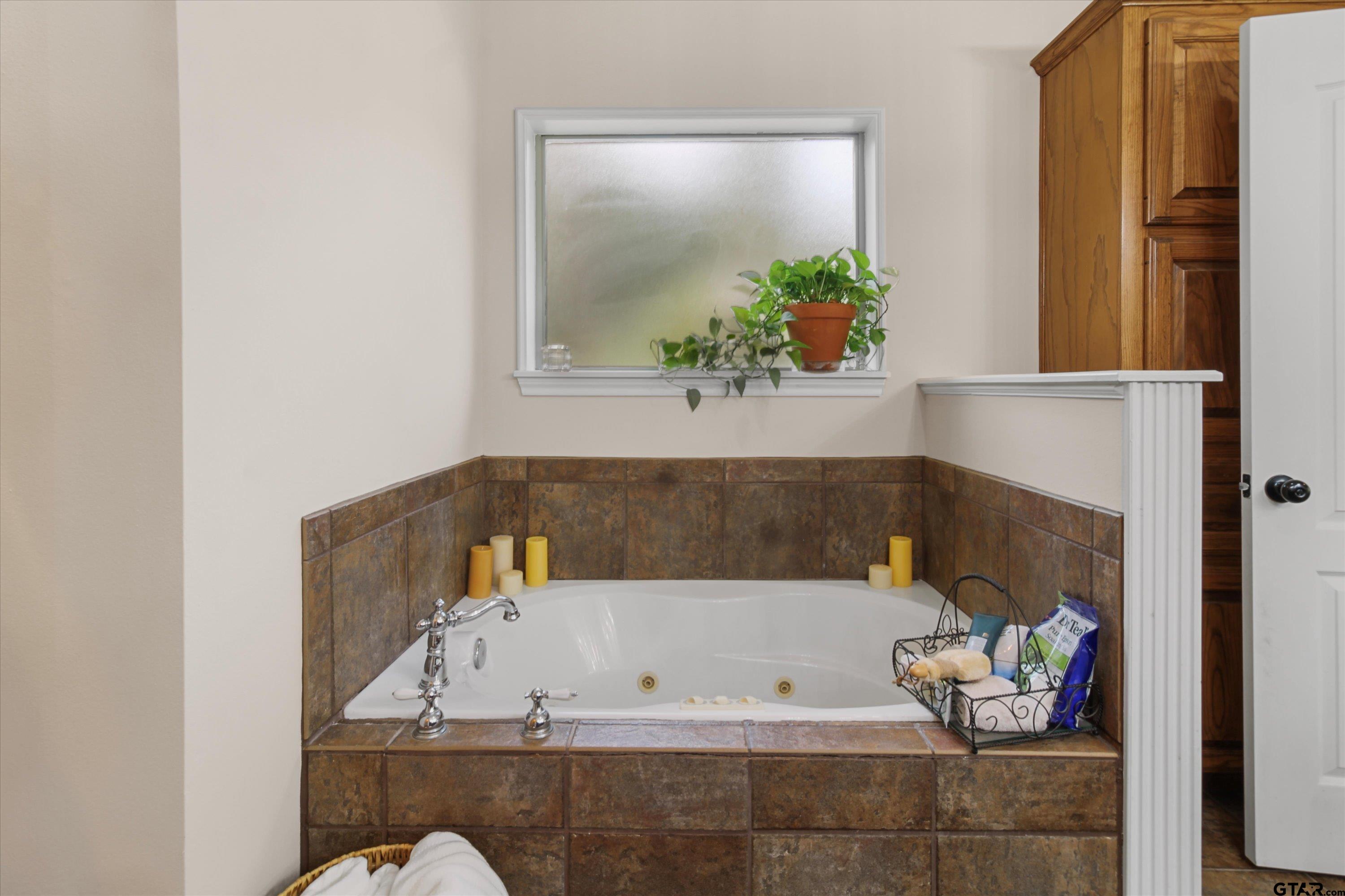 18551 Lazy Lane Flint, TX 75762 - Photo 22 of 45 a bathroom with a tub and potted plant