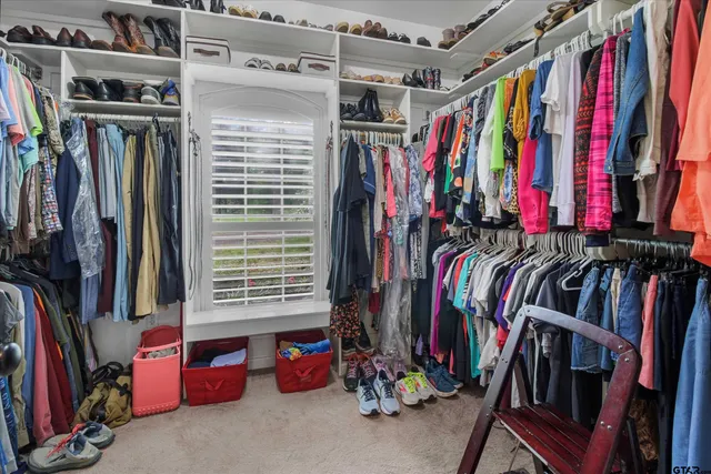 a view of walk in closet with clothes