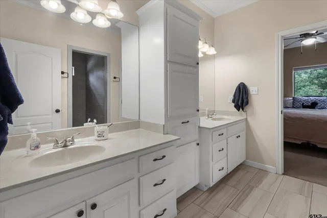a spacious bathroom with double vanity and a mirror