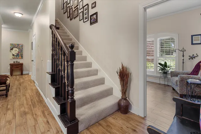 a view of entryway and hall with wooden floor