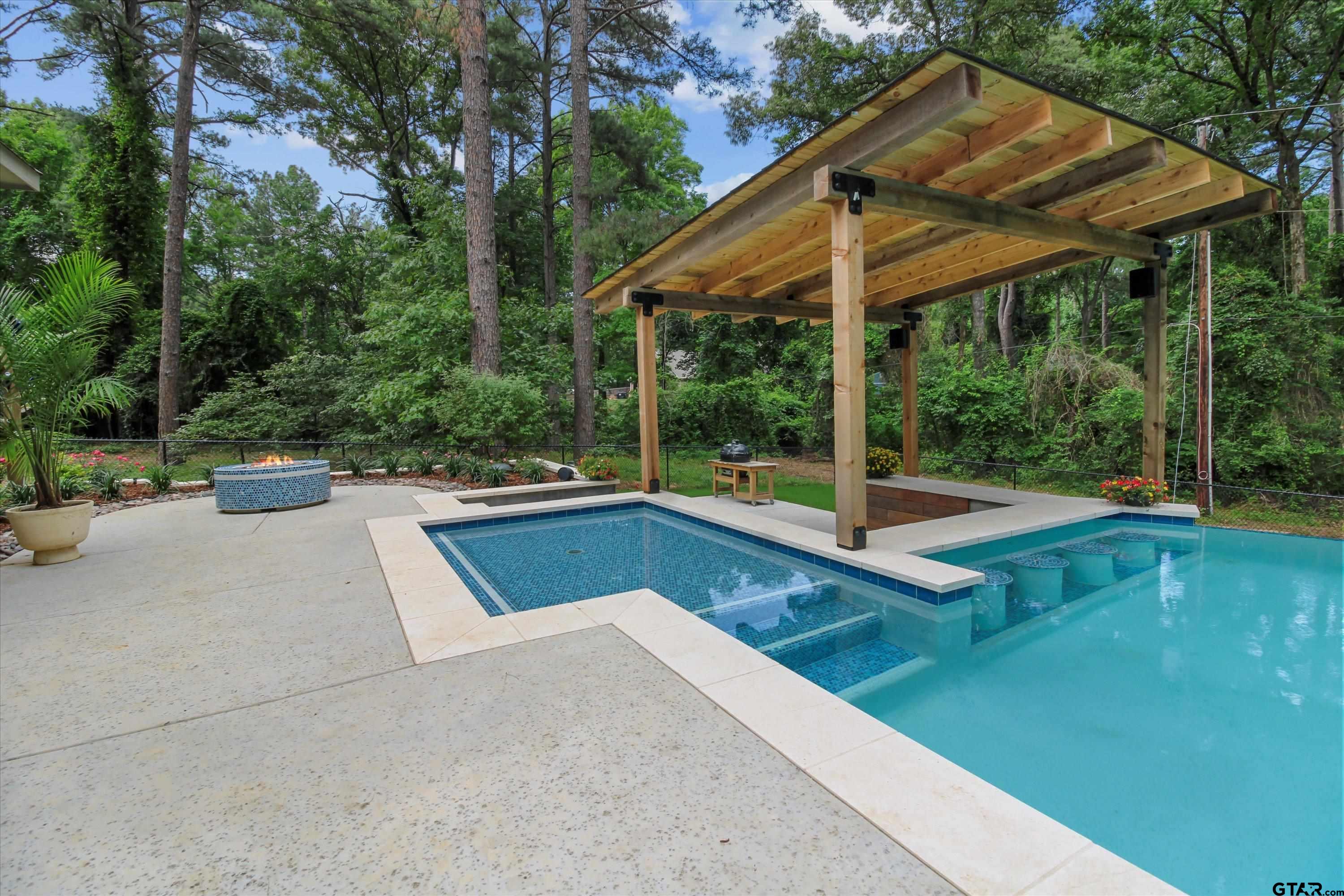 18551 Lazy Lane Flint, TX 75762 - Photo 40 of 45 a view of a patio with chairs and a table