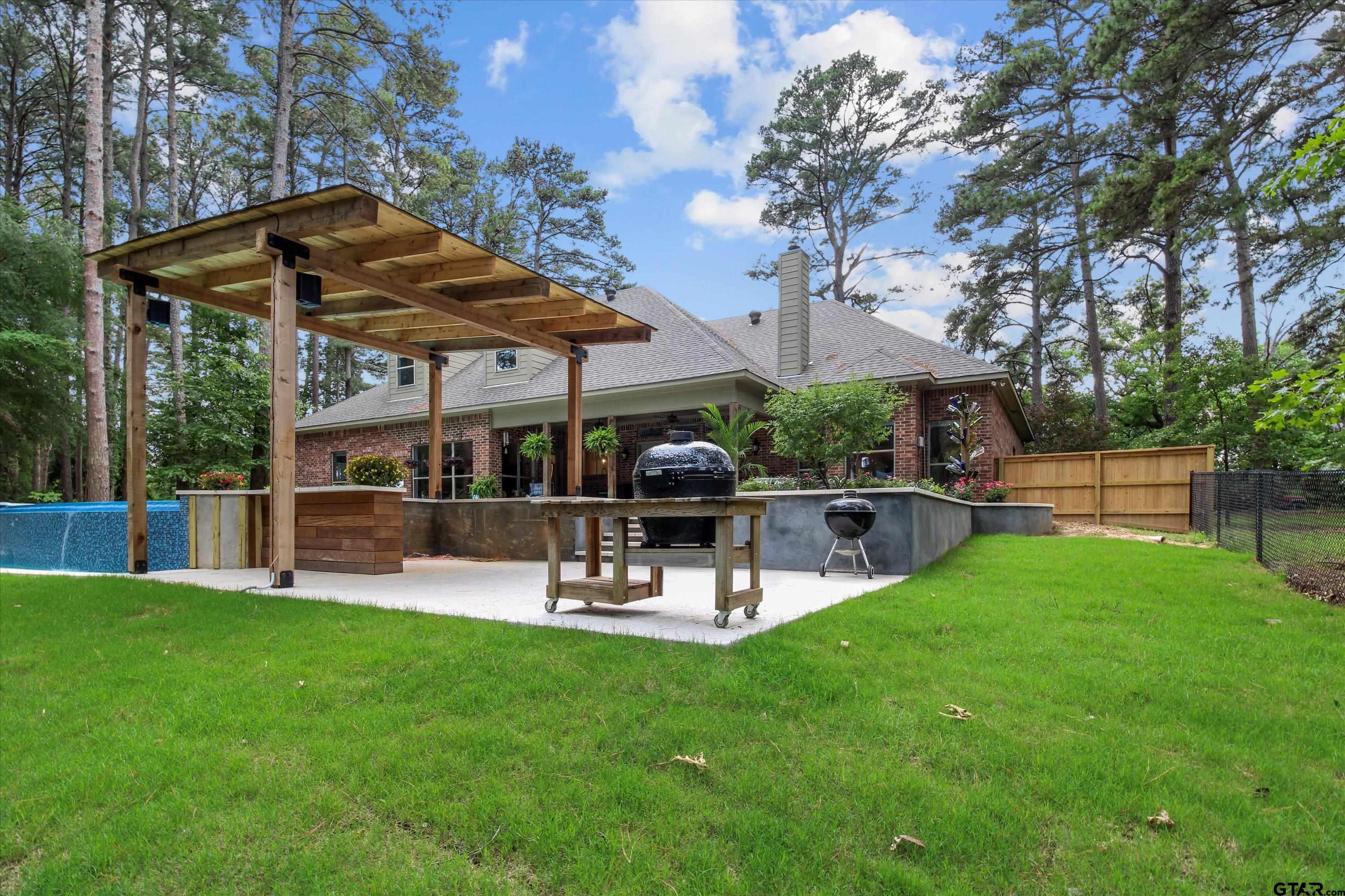 18551 Lazy Lane Flint, TX 75762 - Photo 42 of 45 a view of a patio with table and chairs under an umbrella