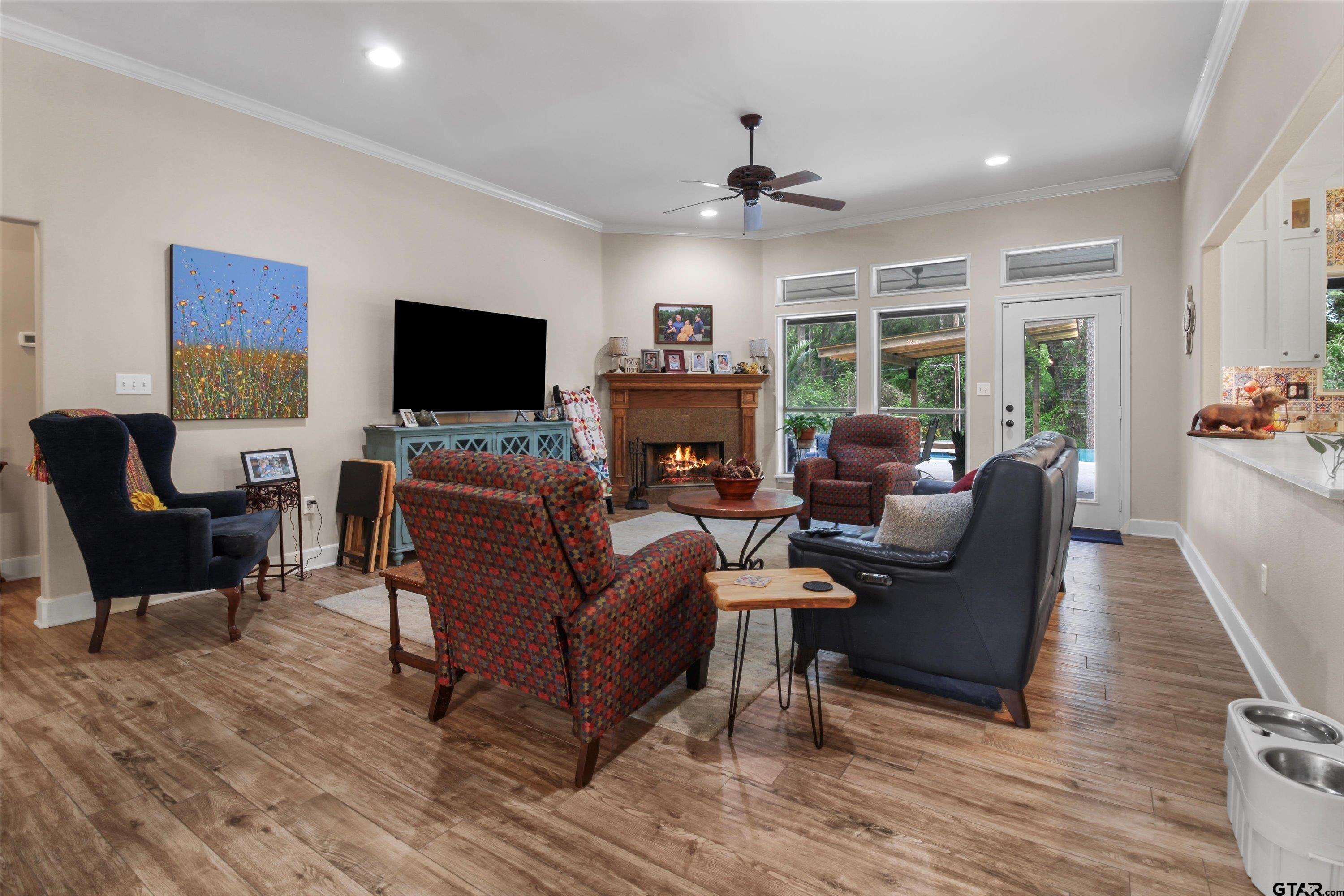18551 Lazy Lane Flint, TX 75762 - Photo 8 of 45 a living room with furniture a flat screen tv and a fireplace
