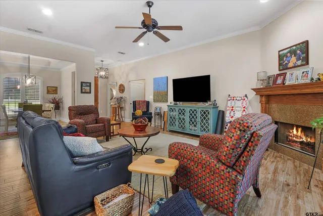 a living room with furniture a flat screen tv and a fireplace