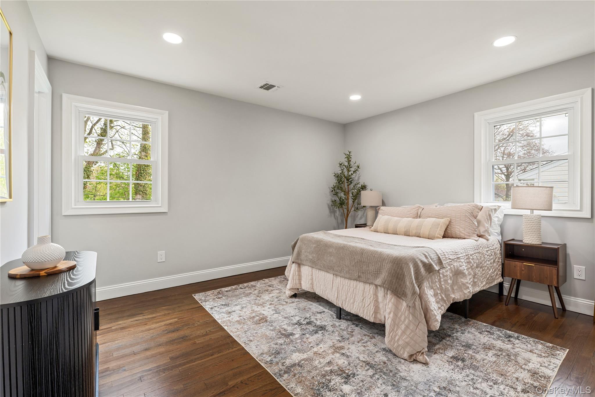 16 Eleanor Road Plainview, NY 11803 - Photo 14 of 28 Hardwood flooring throughout featuring recessed lighting, white trim, and two windows
