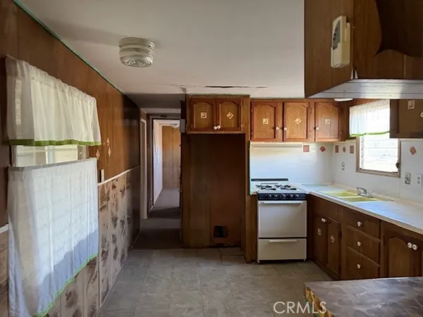 a kitchen with stainless steel appliances granite countertop a refrigerator a sink a stove and island