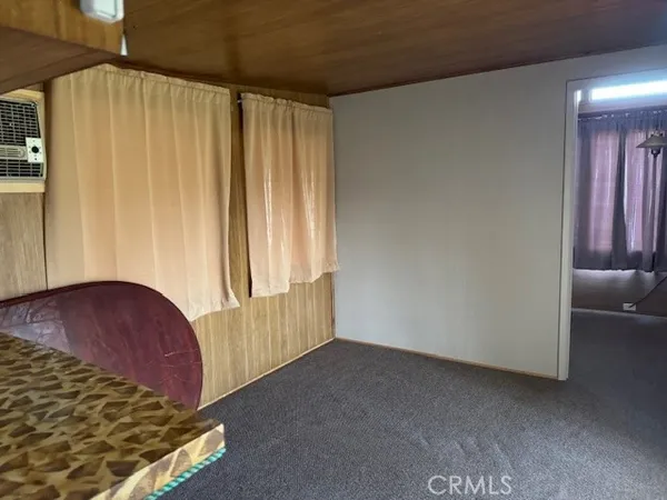 an entryway with wooden floor and cabinet