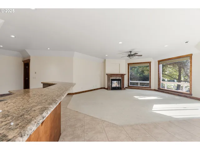 a view of a kitchen with a sink and a large window
