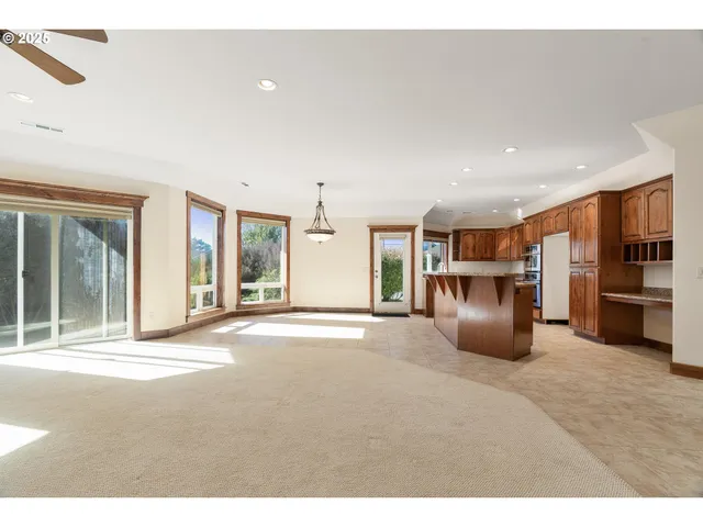 a view of a kitchen with a sink and a refrigerator