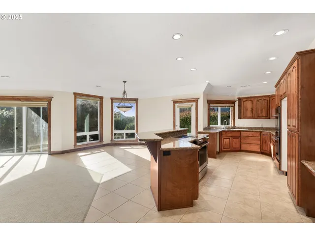 a living room with furniture a flat screen tv and large windows
