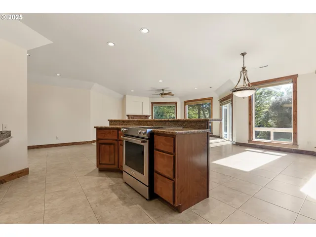 a kitchen with stainless steel appliances granite countertop a stove and a sink