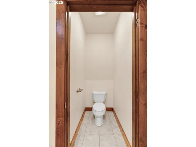 a bathroom with a white toilet