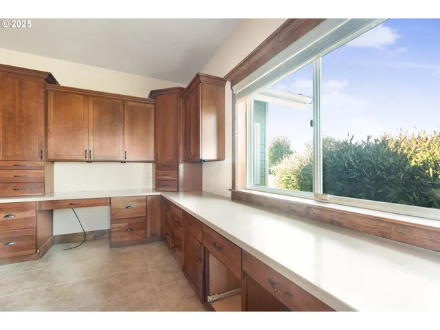a kitchen with a window a sink and a counter top space