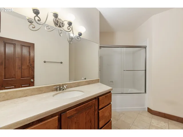a bathroom with a sink a mirror and a shower