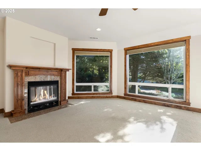 a living room with a fireplace with a floor to ceiling window