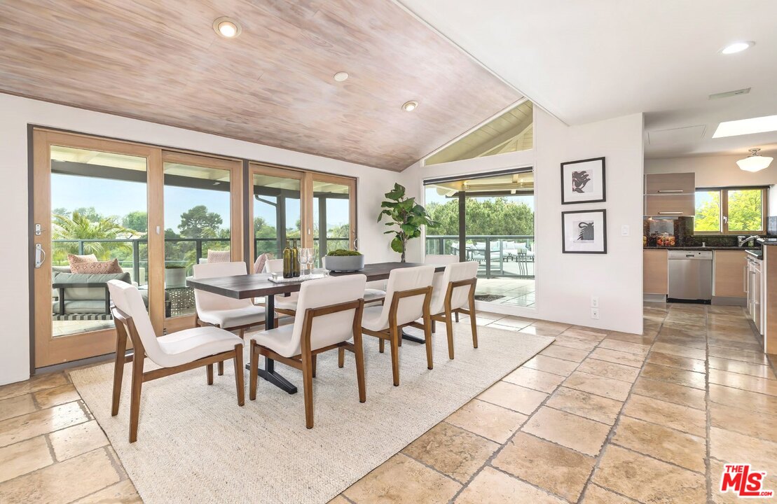 2205 Stradella Road Los Angeles, CA 90077 - Photo 11 of 53 a dining room with furniture and large windows