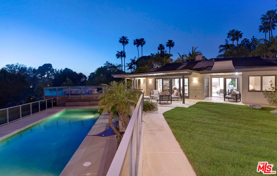 2205 Stradella Road Los Angeles, CA 90077 - Photo 2 of 53 a view of a swimming pool with a patio