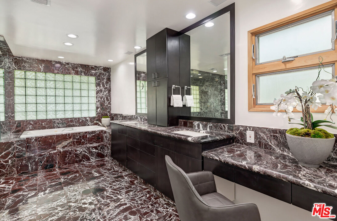 2205 Stradella Road Los Angeles, CA 90077 - Photo 36 of 53 a large kitchen with kitchen island a stove a sink and a granite counter tops