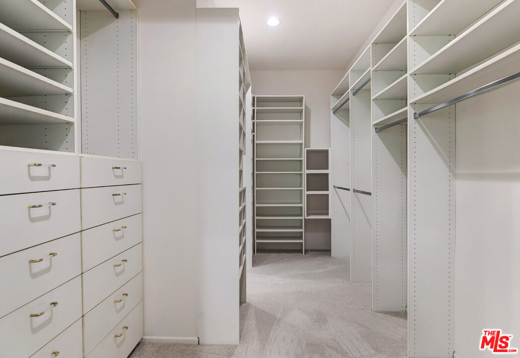 2205 Stradella Road Los Angeles, CA 90077 - Photo 37 of 53 a view of walk in closet with empty racks