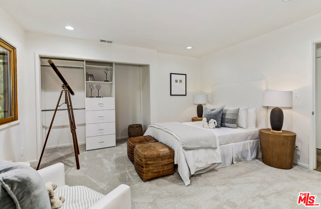 2205 Stradella Road Los Angeles, CA 90077 - Photo 38 of 53 a bedroom with a bed and a flat screen tv