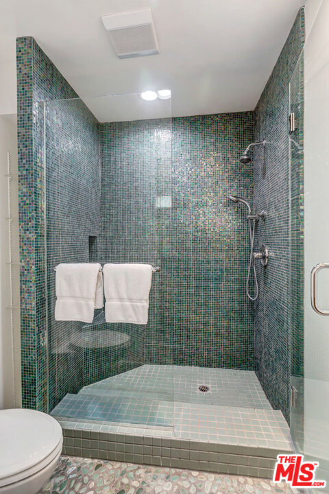 2205 Stradella Road Los Angeles, CA 90077 - Photo 40 of 53 a bathroom with a shower and a toilet