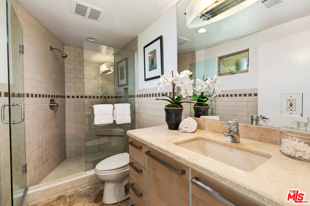 2205 Stradella Road Los Angeles, CA 90077 - Photo 42 of 53 a bathroom with a sink toilet and shower