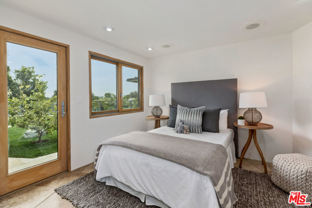 2205 Stradella Road Los Angeles, CA 90077 - Photo 43 of 53 a bedroom with a bed and large window