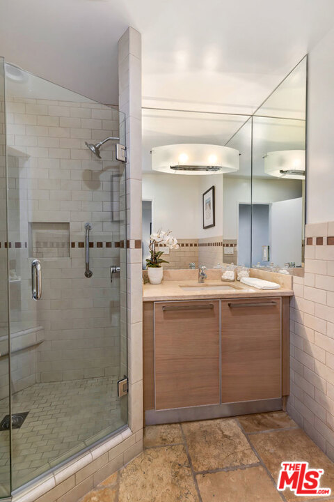 2205 Stradella Road Los Angeles, CA 90077 - Photo 44 of 53 a bathroom with a shower and a sink