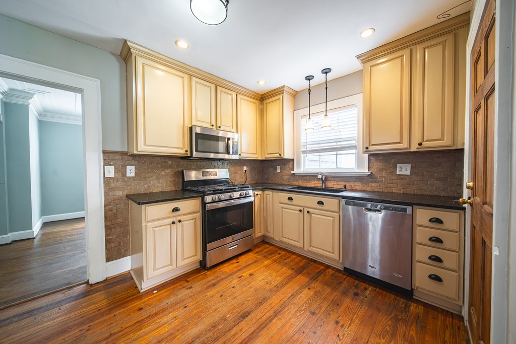1705 Slade Drive Columbus, GA 31901 - Photo 11 of 37 a kitchen with stainless steel appliances granite countertop a stove a sink and white cabinets