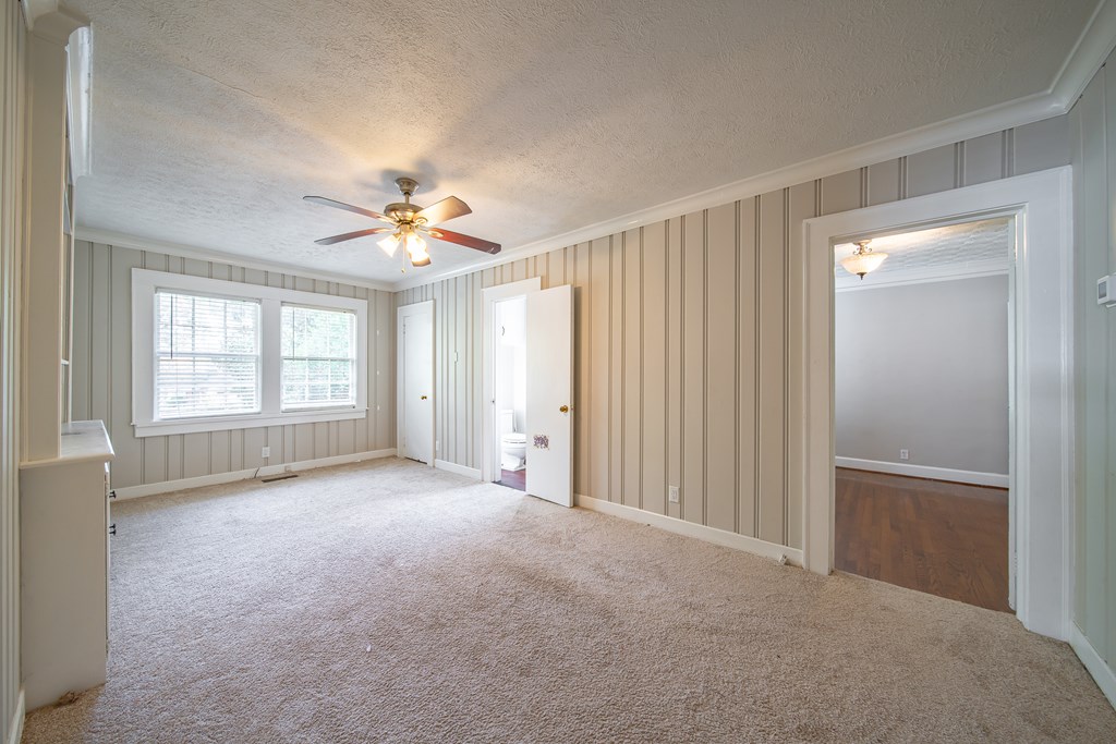 1705 Slade Drive Columbus, GA 31901 - Photo 16 of 37 wooden floor in an empty room with a window