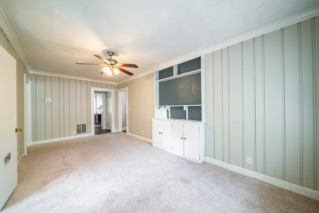 a view of a livingroom with a ceiling fan and window