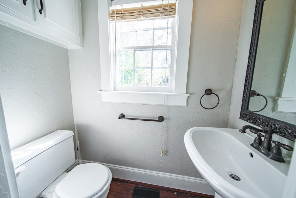 1705 Slade Drive Columbus, GA 31901 - Photo 18 of 37 a bathroom with a sink a toilet and a mirror
