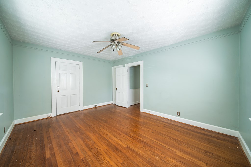 1705 Slade Drive Columbus, GA 31901 - Photo 27 of 37 a view of a big room with wooden floor and chandelier fan